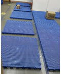 Interlocking Plastic Pallets For Basement And Garage Storage in blue polypropylene with ventilated mesh design on floor.