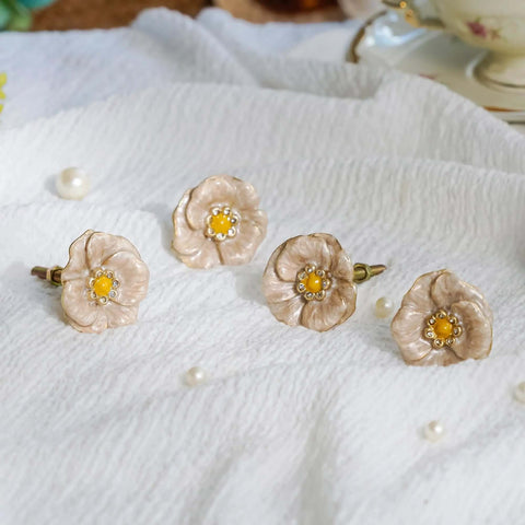 Premium Zinc Alloy Cabinet Knobs 4 Pack Featuring Floral Rhinestone Inlays with vintage yellow flower design on white fabric.