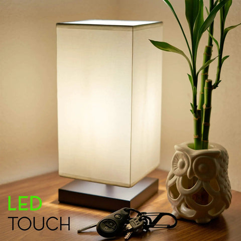 Lucerna 13-Inch Modern LED Touch Table Lamp With Oil Rubbed Bronze Finish And White Fabric Shade on wooden table with keys