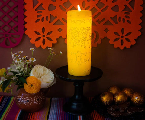 Encanto Alma's Miracle LED Flameless Candle Replica With Auto Timer Disney Officially Licensed Collectible Mood Light displayed on a table with flowers and decor.