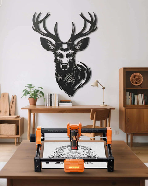 ACMER S2 12W laser engraver on wooden table; orange and black, front view