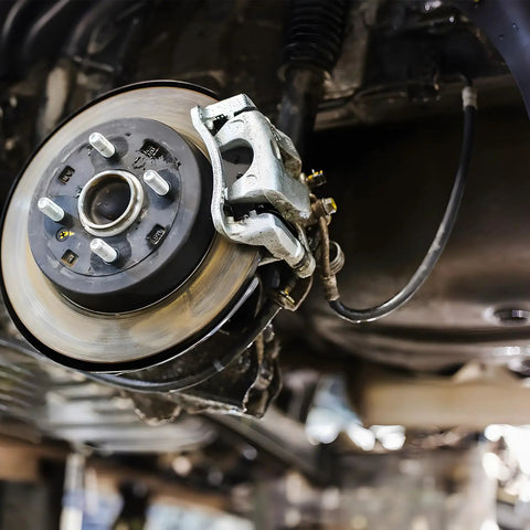 Installed Universal 18-Inch Rubber Brake Hose, 3/8-24 External To 3/8-24 Internal Threads, durable black hydraulic brake line.