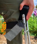 Close-up of Knee Seat For Gardening And Farm Work Strap On Kneeling Device To Save Your Labor with iron frame strapped to leg.