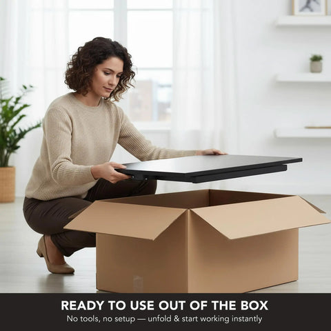 Woman unpacking 32 By 22 Inch Standing Desk Converter With Gas Spring Lift Slim Two And A Half Inch Low Profile Sit Stand Desk Riser