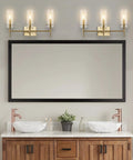 Brass Gold Modern Farmhouse LED Vanity Light Sconce With Clear Glass Cylinder Shade for bathroom over mirror with dual sinks.