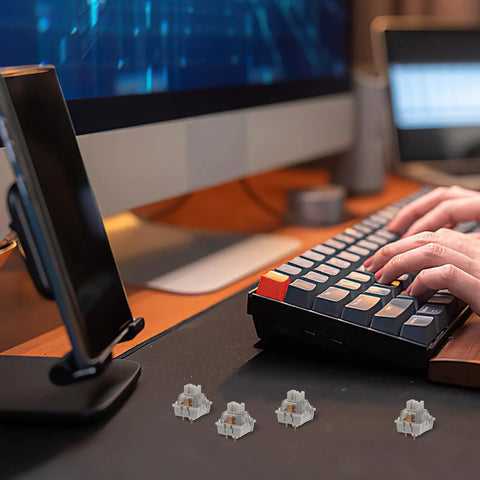 Close-up of a user typing on a mechanical keyboard with 10 Pack Linear Switch Stems For Mechanical Keyboard Mods featured in gray.