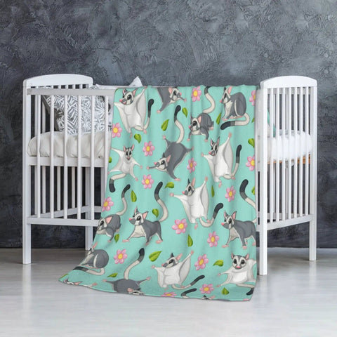 Super Cute Sugar Glider Throw Blanket For Kids And Girls, Hella Soft Weightless Plush Blend, hanging over a crib, playful design.