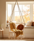 Beige Macrame Hammock Chair With 350 Pound Capacity Handwoven Tassels Boho Hanging Chair for indoor cozy window space.