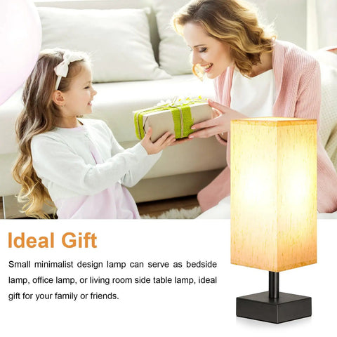 Small Table Lamp For Bedroom And Nightstand With Square Fabric Shade next to a child receiving a gift, ideal for cozy spaces.