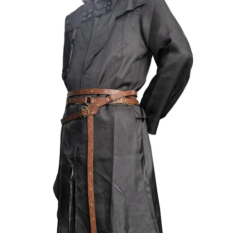 Snag This Fresh Medieval Faux Leather Wrap Belt To Kick Up Your Vintage Look With Adjustable Chain Details And A Snug Custom Fit That Elevates Your Everyday Streetwear Game Instantly. Brown faux leather belt with chain details worn over a black coat.