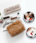 Fluffy brown bag and makeup items with customized photo trays featuring a woman with child and a dog, next to floral arrangement.