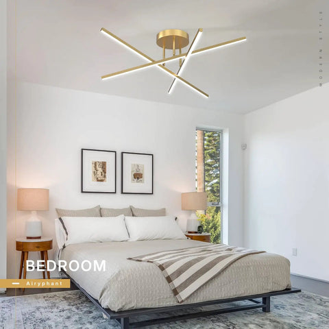 Gold LED Chandelier Three Lights Modern Semi Flush Mount Ceiling Fixture For Kitchen Dining Room Foyer Entry And Bedroom 24 Inches 25W Adjustable Arms For Custom Sleek Lighting in a bedroom setting with white walls and framed art.