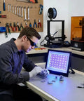 Man using 3D Printer UV Resin Curing Light With Timer For SLA DLP LCD 3D Printers, rapid curing of resin models in workshop