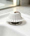 Bathtub Drain Strainer Silicone Bathroom Stopper Fixture in white, preventing hair clogs in the bathtub drain.