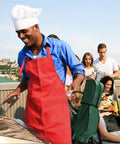 Man grilling on a rooftop with a group, using the Golf Themed 8 Piece Barbecue Grill Utensils Set With Golf Club Spatula Golf Ball Tongs And Two Golf Ball Salt And Pepper Shakers For Outdoor Cooking And Camping A Great Gift For Golf Lovers Men Women Dad Husband Grandpa.