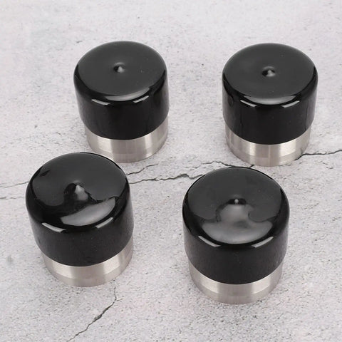 Stainless Steel Boat Trailer Hub Bearing Kit For 4 And 5 Bolt Hubs with black caps on concrete background.