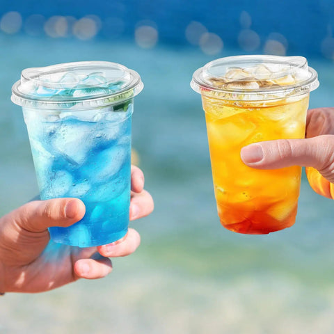 Two hands holding 16 Oz Clear Plastic Cups With Lids 50 Pack For Iced Coffee And Cold Drinks Strawless Sip Lids Perfect For Parties Outdoors
