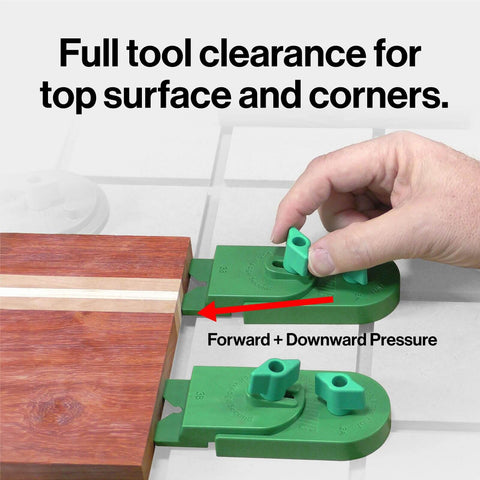 Hand using Matchfit Inline Dovetail Ramp Clamps for track system with low profile rotating heads on wooden board