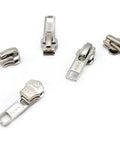 Zip Repair Kit With Metal Aluminum Sliders And Top And Bottom Stops, Assorted Sizes 3, 4.5, 5, And 10, Easy Storage Container, Fix Broken Zippers Fast - image showing five metal zipper sliders on white background