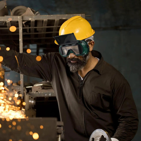 Top Shelf Flip Up Welding Goggles With Anti Scratch Lens For Metalwork And Industrial Eye Protection Featuring A Breathable Vent Design worn by a worker.