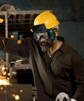 Rock Solid Industrial Welding Goggles Flip Up Safety Glasses With Impact Tough Lenses And Dustproof Shield For Welder Eye Protection worn by a man during metalworking.
