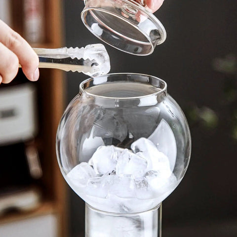 Premium Glass Cold Brew Drip Tower With Adjustable Flow Dripper For Smooth Cold Extraction Coffee Maker 600 Milliliter Gray Body adding ice cubes.
