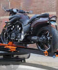 Heavy Duty Endless Ratchet Straps No Hook Setup One Inch By Eight Feet 1860 Pound Break Strength Black Cargo Tie Downs securing a motorcycle in a truck bed.