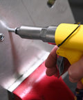 Person using air riveter with quick change nosepieces for 3/32 inch through 1/4 inch capacity on metal surface