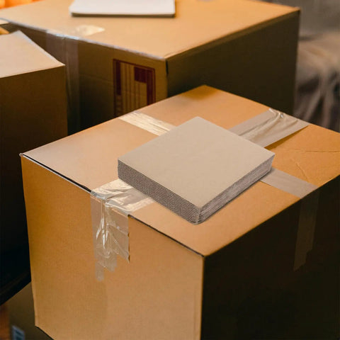 Corrugated Paper Filler Sheets 20X20 CM Pack Of 12 Cut-To-Size Protective Inserts for moving boxes on top of a cardboard box.