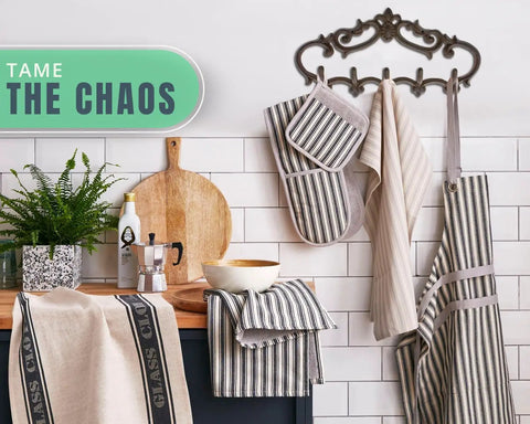 Knockout Five Hook Cast Iron Wall Hanger In Rustic Brown Fleur De Lis Farmhouse Entryway Coat Rack with striped kitchen towels.