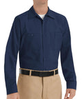 Men's Regular Fit Long Sleeve Industrial Work Shirt In Solid Navy With Slick Moisture Wicking Fabric And Quick Dry Tech on a model.