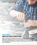 Person assembling electronics with tools, highlighting protection function. Close-up with focus on circuit board and workspace.