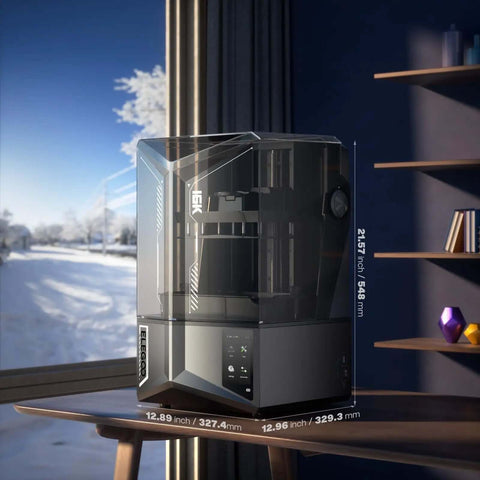 Saturn 4 Ultra 16K Resin 3D Printer With 10 Inch Mono LCD on desk, showing transparent lid, in modern room with window view