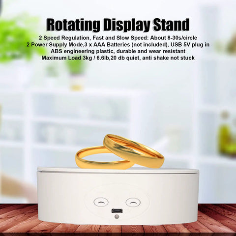 Heavy Duty Electric Rotating Display Stand With 6.6lb Load Capacity showing gold rings on a stable white base in a studio setting.