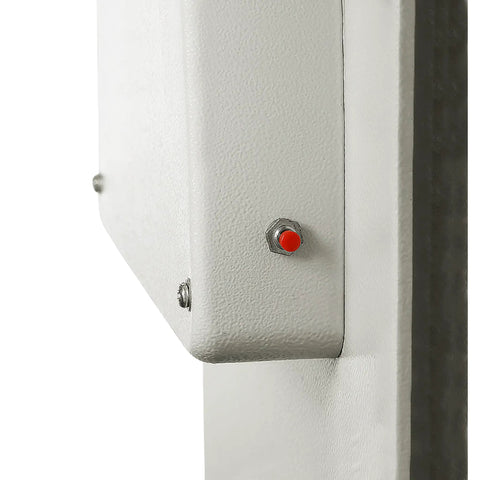 Close-up side view of hidden in-wall safe lock mechanism with visible red button and metal hardware, easy to install for home or office use.