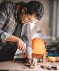 Man using a screwdriver to work with wood, featuring Heavy Duty M6 X 15mm Flat Phillips Head Machine Screws Built Dang Tough From 304 Stainless Steel.