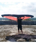 Person holding Handheld Inflatable Surf Wing for Windsurfing and Kiteboarding Do It All Water Sports Wing, TPU material, outdoor setting