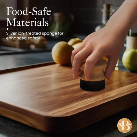 Hand using Oil Applicator Brush For Cutting Boards And Wooden Utensils on bamboo board, silver-ion sponge visible