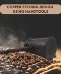 Antique Copper Turkish Coffee Pot With Wooden Handle For Authentic Cezve Ibrik Briki Brewing Greek And Arabic Style Thick Brew On The Stove Medium Size Rich Flavor And Even Heat For Perfect Home Brewed Espresso Style Coffee, side view on coffee beans.