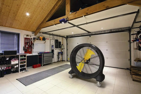 Kick Serious Heat To The Curb With This Heavy Duty 42 Inch Portable Barrel Fan in a garage setting.