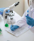 Laboratory setting with a researcher wearing Top Shelf Blue Nitrile Exam Gloves Real Deal Latex Free Powder Free Medical Grade.