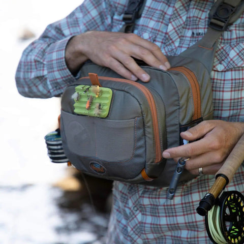 Man using Cross Current Chest Pack For Fly Fishing Gear, Durable 210D Nylon Cyclepond Fabric with magnetic pocket and compartments
