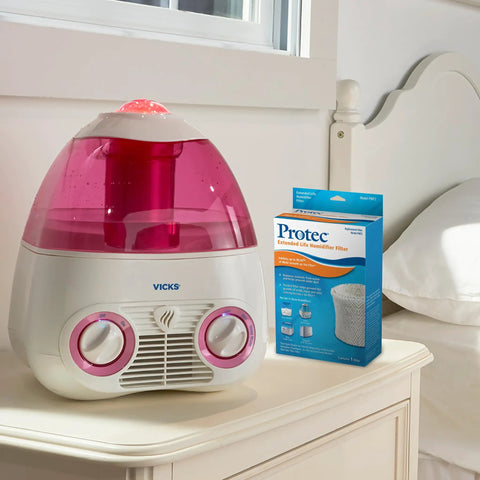 Vicks Cool Mist Humidifier on nightstand with Protec filter box, part of Vicks Cool Mist Humidifier Wicking Filter Replacement Pack of 3