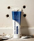 Easy Diy Drywall Repair Paste For Quick Fixes That Seals Cracks And Holes Tile Grout And Concrete Shower Floor Waterproof Sealant Wall Mending Paste Tube shown with tools on wall