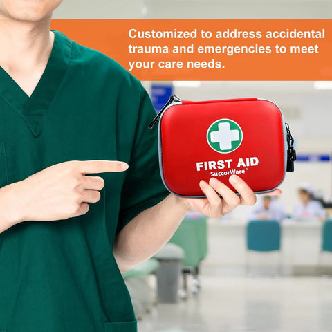 Red hard-shell SuccorWare mini first aid kit held by person in green scrubs, front view.