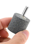 Close-up of 10Pcs 30mm Aluminum Oxide Mounted Grinding Stone with quarter inch shank for rotary tools, cylindrical shape for metal and wood.