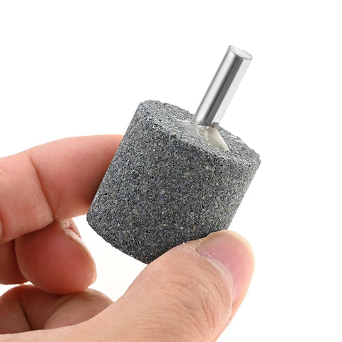 Close-up of 10Pcs 30mm Aluminum Oxide Mounted Grinding Stone with quarter inch shank for rotary tools, cylindrical shape for metal and wood.