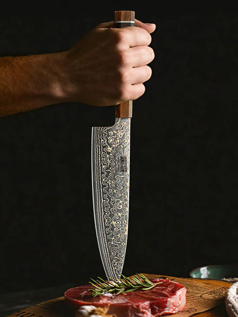 Hand holding 8 Inch Damascus Chef Knife 33 Layer Copper Pattern V Shaped Blade above raw meat with herb garnish.