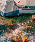 Cast Iron Camp Pie Cooker Set Of 2 for Campfire Sandwiches and Pies over open fire beside tent, extra long wooden handle grips