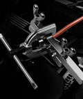Brake line flaring tool kit clamped to orange copper tubing in engine bay (close-up)
